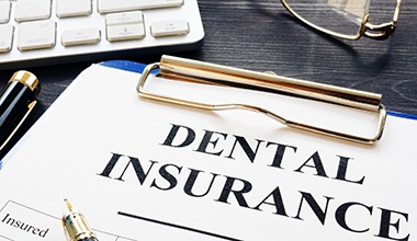 Dental insurance form on clipboard 