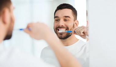 man brushing his teeth to prevent dental emergencies in Worthington 