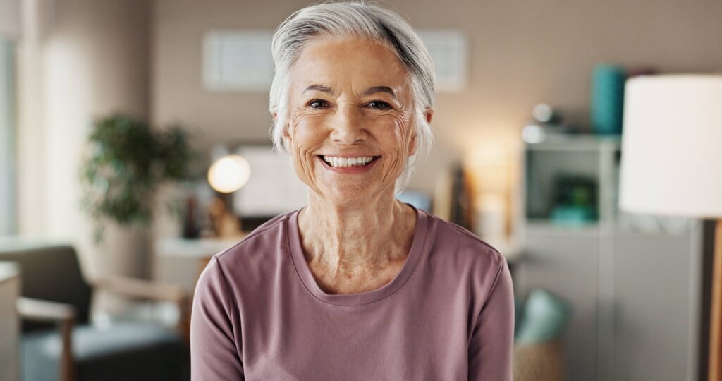 Closeup of woman with beautiful smile in living room